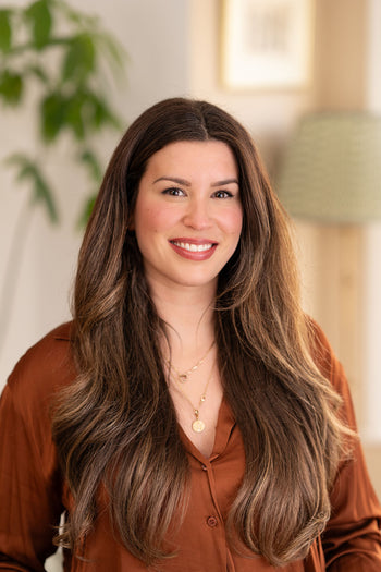 Smiling lady in brown shirt.