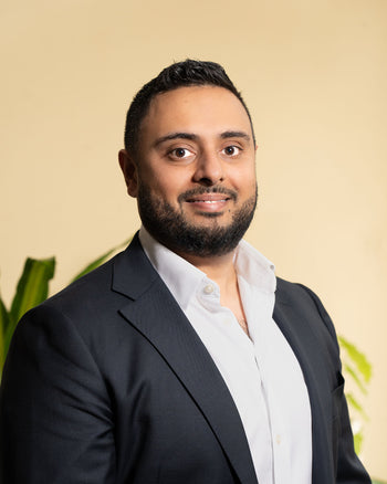 Man in suit smiling.