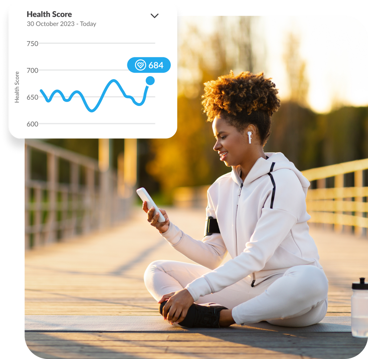Lady sitting on wooden decking, looking at phone with an example health score graph visible